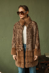 Camel Swakara long jacket featuring a textured moire pattern, a smooth stand-up collar, and a bottom section with horizontal fur panels.