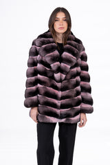 A short chinchilla jacket with a wide shawl collar, featuring alternating horizontal bands of dark grey and pink powder fur in a clean fit.
