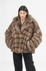 Short marten fur jacket featuring a large collar and a multi-directional chevron pattern with panels angled towards the center.