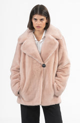Short light pink mink jacket with a wide notched collar, single button closure, and side pockets, worn over a white collared shirt.