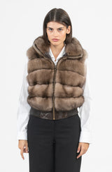 A zip-front Russian sable fur vest featuring a high collar and horizontal fur panels, finished with a dark leather hem and ribbed trim.