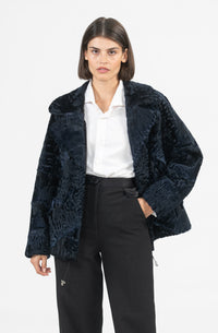 Model wearing a stylish Swakara fur coat by manzari